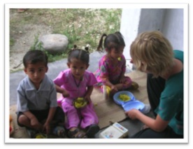 Volunteer assisting with mealtimes at a children’s project in India