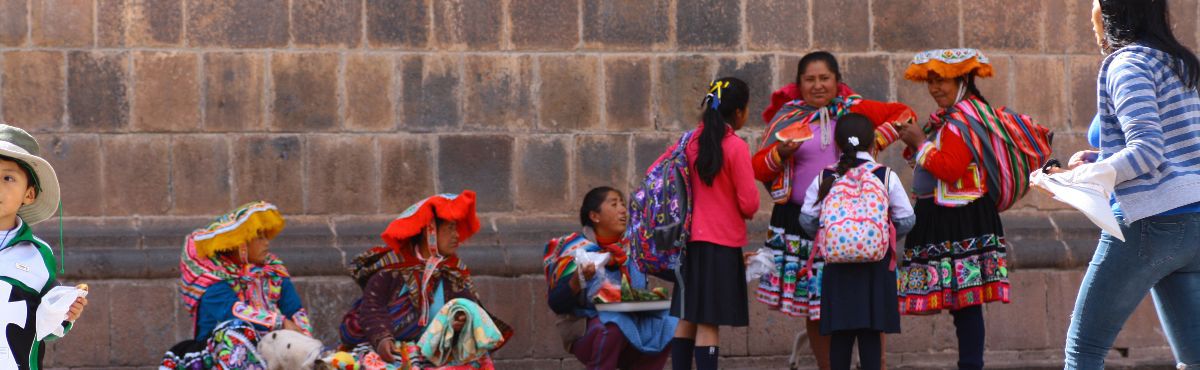 group of people on the street in traditional cusco clothing
