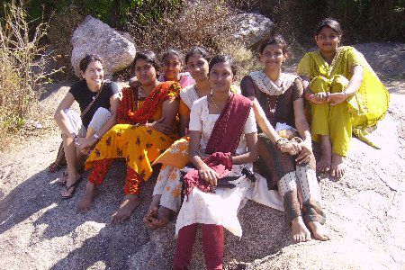 volunteer sitting with a group of local women at a project