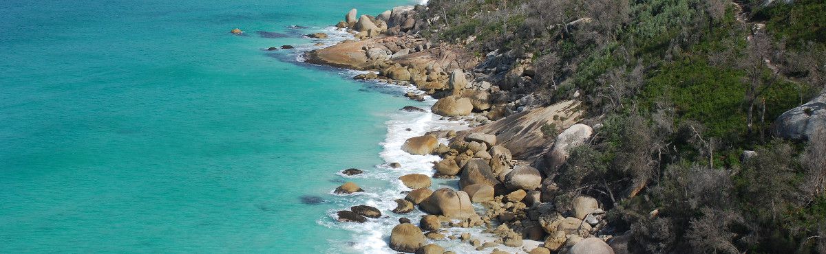 large rock and blue water coastline in Australia