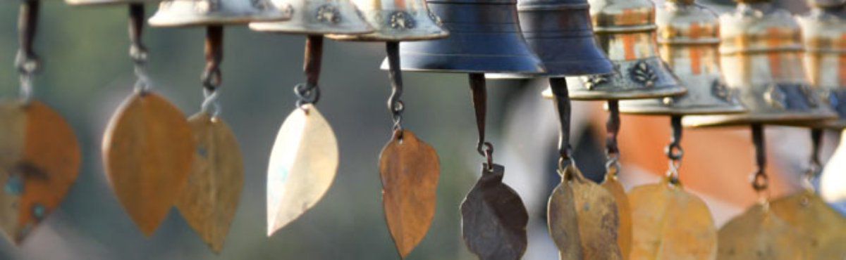 brass and silver wind chimes at market