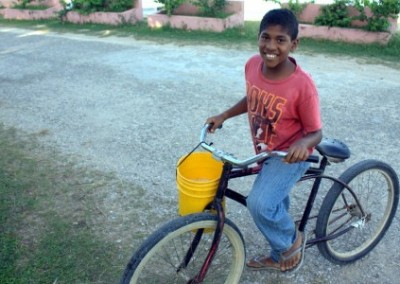 Belizian boy on bike spring break farming Belize