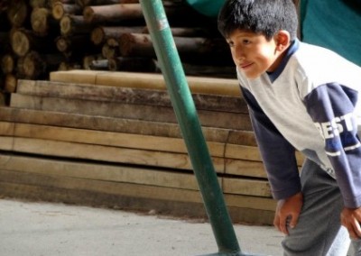 Child playing football sports coaching and community work Bolivia