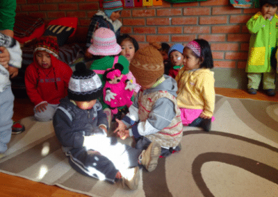 Children playing on carpet family community development Bolivia