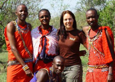 Kaya Director posing with 4 Masai tribe members dressed in cultural attire