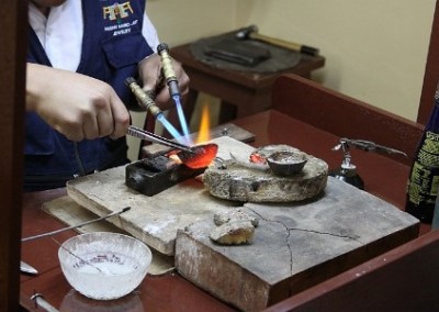 Heating metal Inca jewellery making cooperative Peru