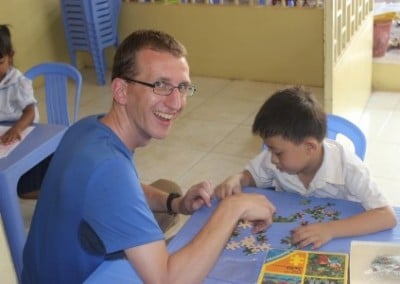 Helping with a puzzle Classroom and Childcare assistant in Cambodia