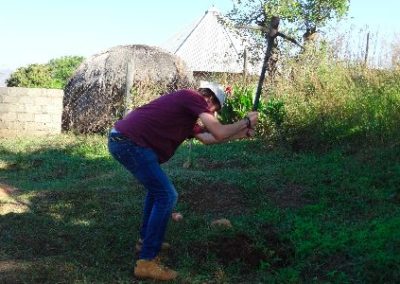 building project volunteer in Swaziland with a pick axe