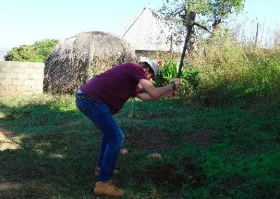 building project volunteer in Swaziland with a pick axe