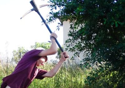 building project volunteer in Swaziland with a pick axe