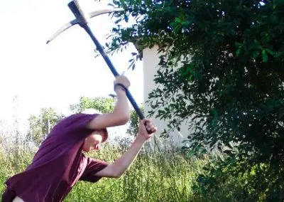 building project volunteer in Swaziland with a pick axe