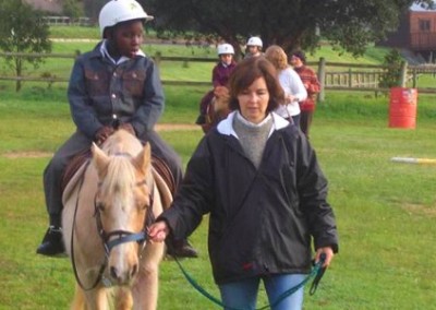 Leading a child equine therapy for disabled children South Africa