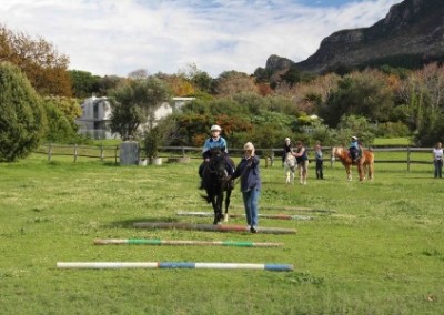 Leading a child over obstacles equine therapy for disabled children South Africa