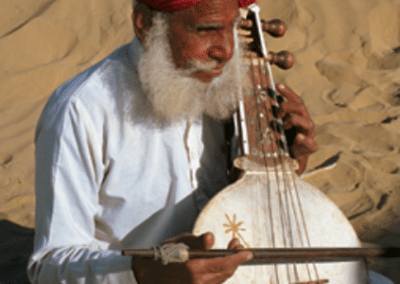 Man playing instrument Medical Assitance in India