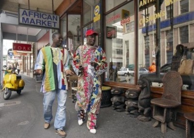 Men walking in colourful clothes support the recovery of children in a hospital South Africa