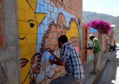 Painting a mural familty community development Bolivia