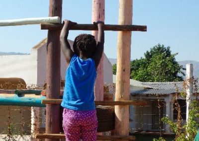 Playing on the climbing frame pre-school children building volunteer project Swaziland