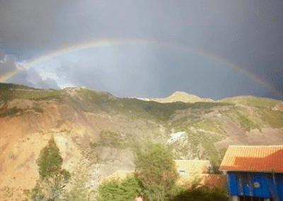Rainbow over cliff construction and animal welfare Bolivia