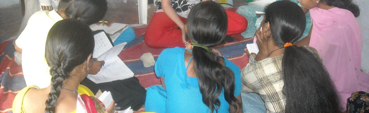 Sitting writing Women's Empowerment in India