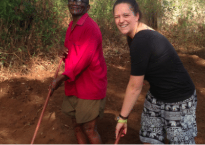 Volunteer and local digging Rural Volunteer Teaching in Tanzania