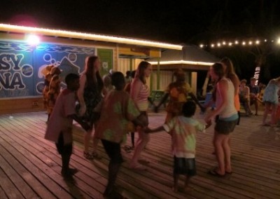 Volunteers and children circle dance therapy Belize