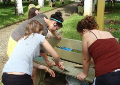 Volunteers repairing a bench family community beautification Costa Rica