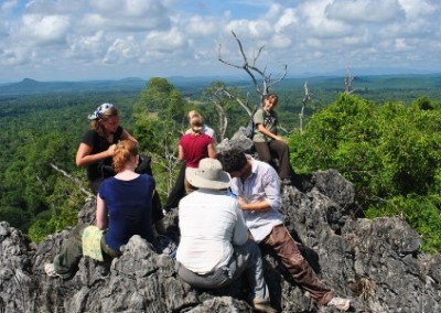 Volunteers sat on rocks environmental conservation and community empowerment in Borneo