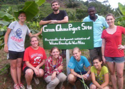 Volunteers with project sign Agriculture for Education in Ghana
