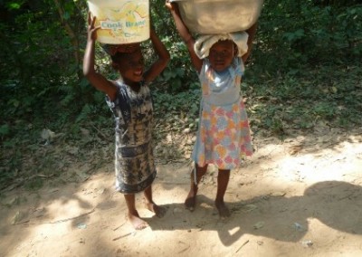 Children carrying water Mobile Literacy Development in Ghana