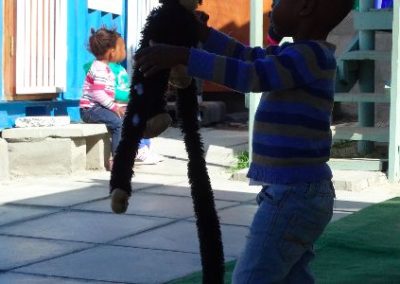Hout Bay Child at play with monkey Early Years Internship in Cape Town