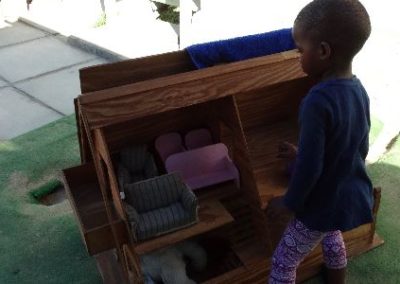 Hout Bay Child playing with dollshouse Early Years Internship in Cape Town