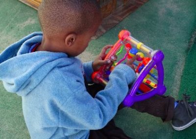 Hout Bay Child playing with plastic toy Early Years Internship in Cape Town