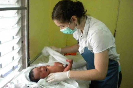 medical volunteer on a project with a baby medical volunteer on a project with a baby