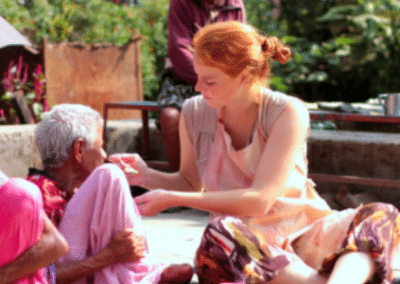 volunteer-feeding-local-elderly-lady-gap-year-india