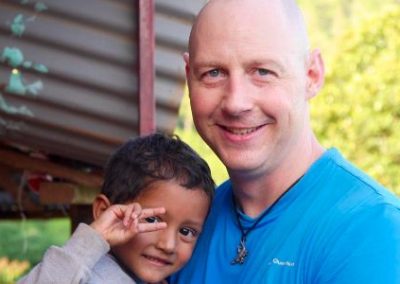 Volunteer holding child Family volunteering Nepal