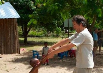 Volunteer playing with a child community sports coaching South Africa