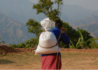 Woman carrying sack Empower Women on Sustainable Agriculture Initiative in Nepal