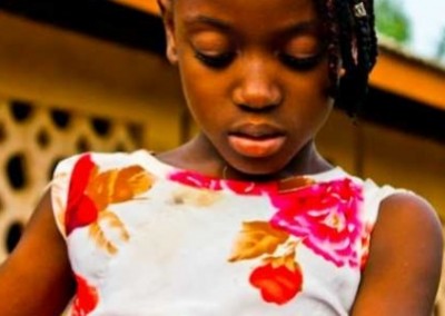 Young girl with a book Mobile Literacy Development in Ghana