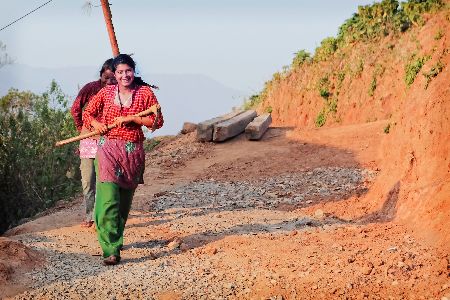 Rebuilding life in Nepal after the 2015 earthquake lady with a hoe