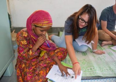 Volunteer teaching girl Volunteering for 16 and 17 year olds in India