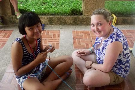 Hannah and girl knitting together
