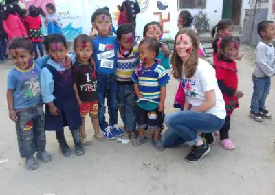 Volunteer with group of children Holi festival India