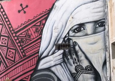 A mural of a woman in a veil.