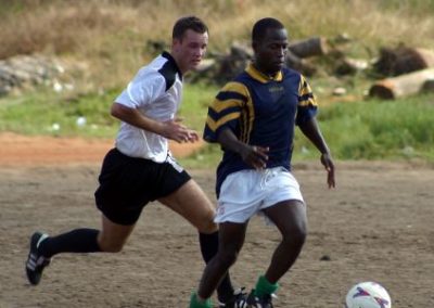 Coach and student playing football