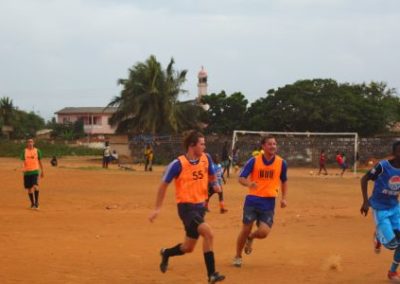 Coaches and students playing football