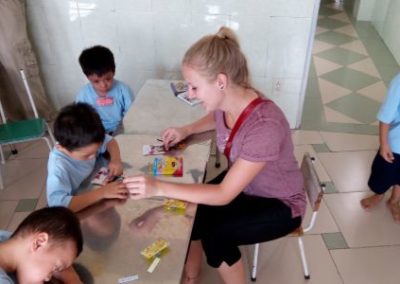 A volunteer engaging in activities with children in Vietnam.