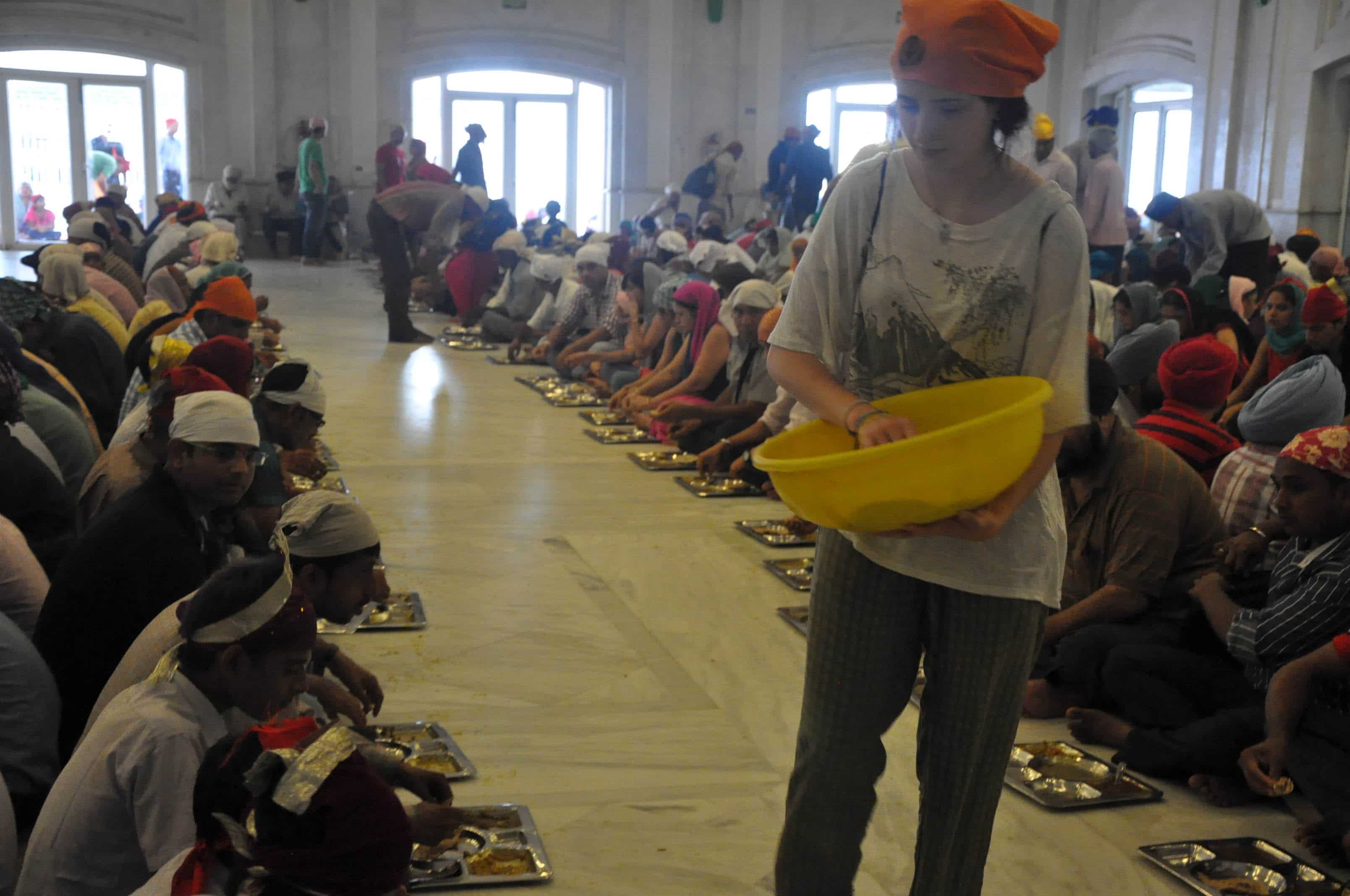 Girl distributing food India