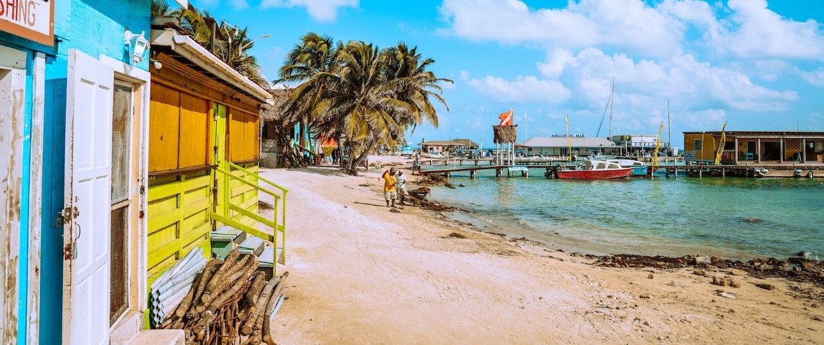 beach huts belize Beach huts on white sandy beach pier