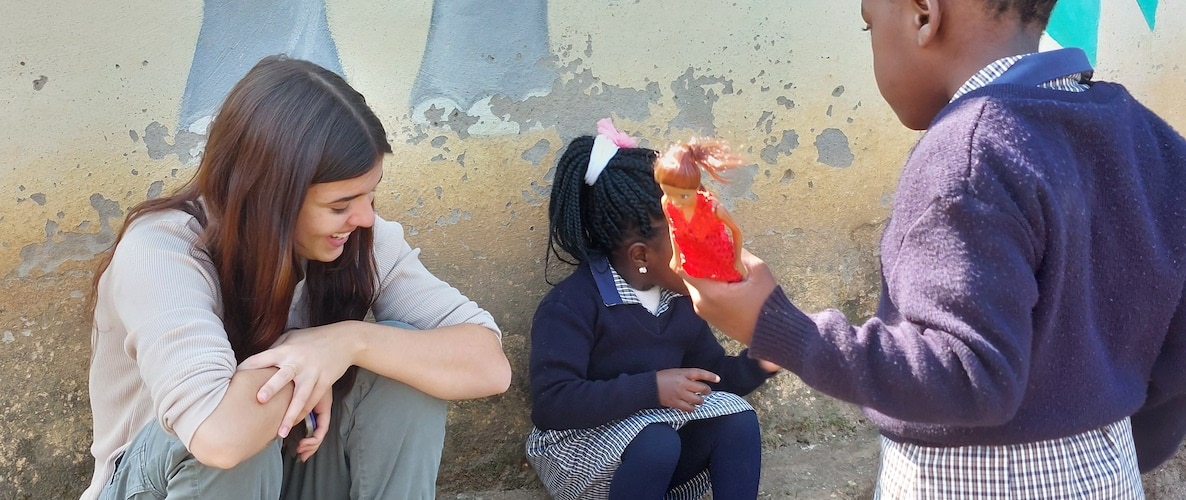 NAZ SA-Eswatini 2023 May (1165) volunteer sitting with 2 school girls