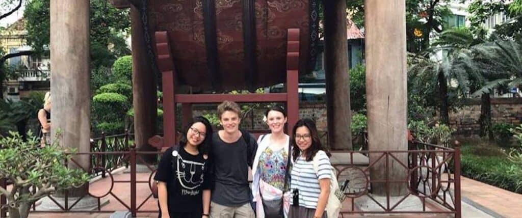 intern with colleagues at Vietnam temple